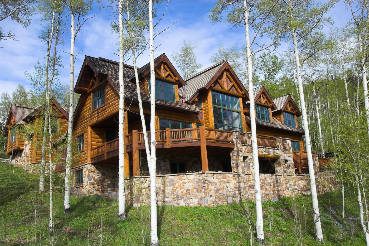 Premium log home among tall aspen trees